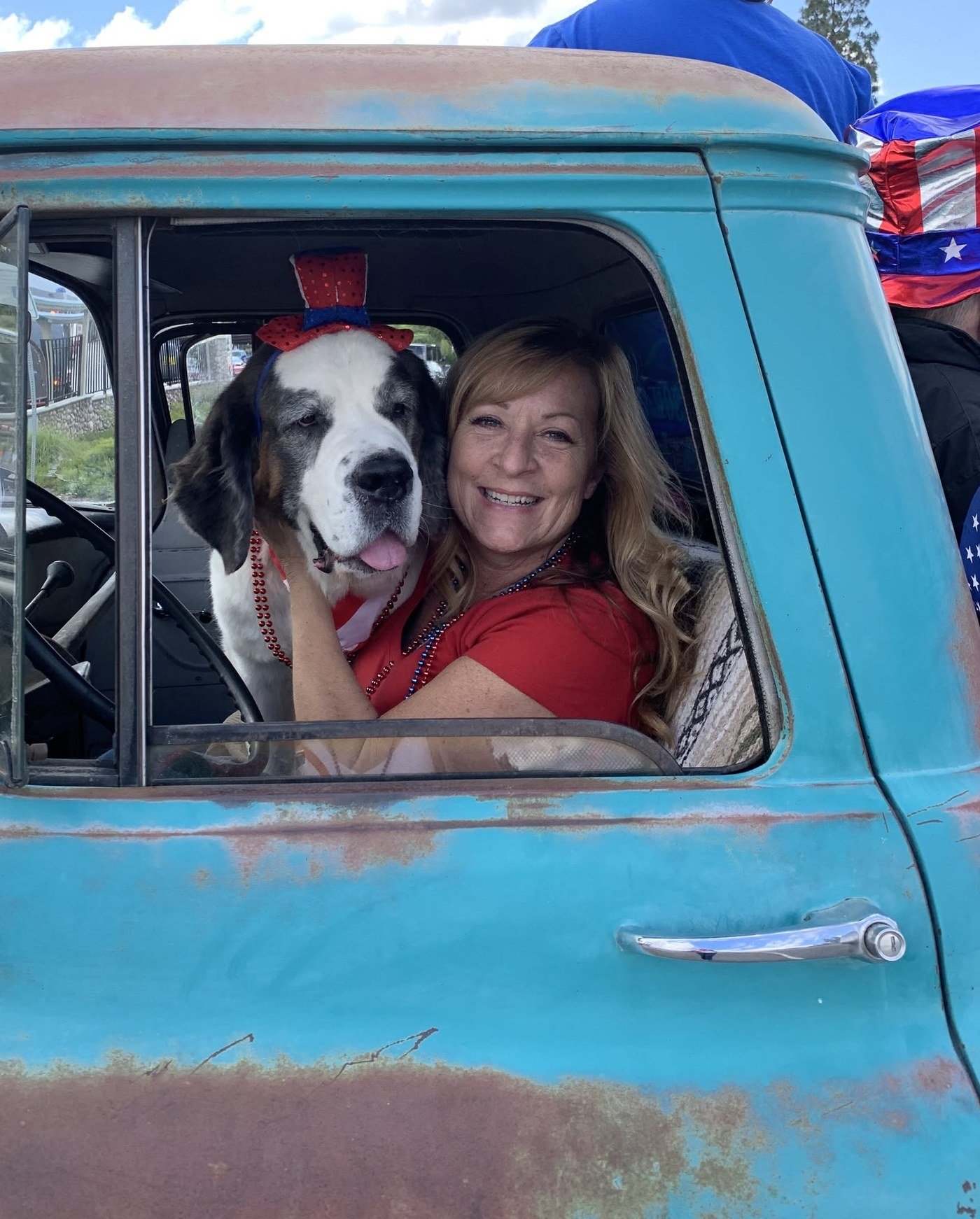 Linda Knutson with Duchess in a vintage blue truck